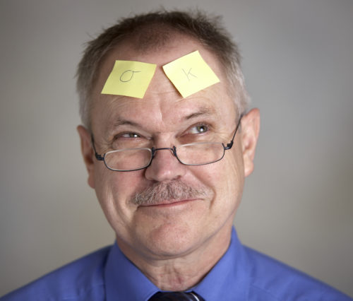 Man with post it notes on forehead