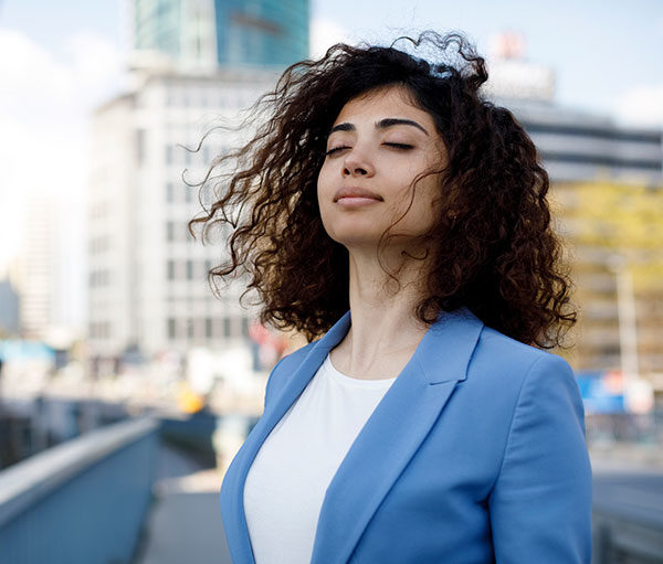 woman practicing mindfulness on a city street