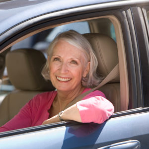 Senior woman behind the wheel of her car